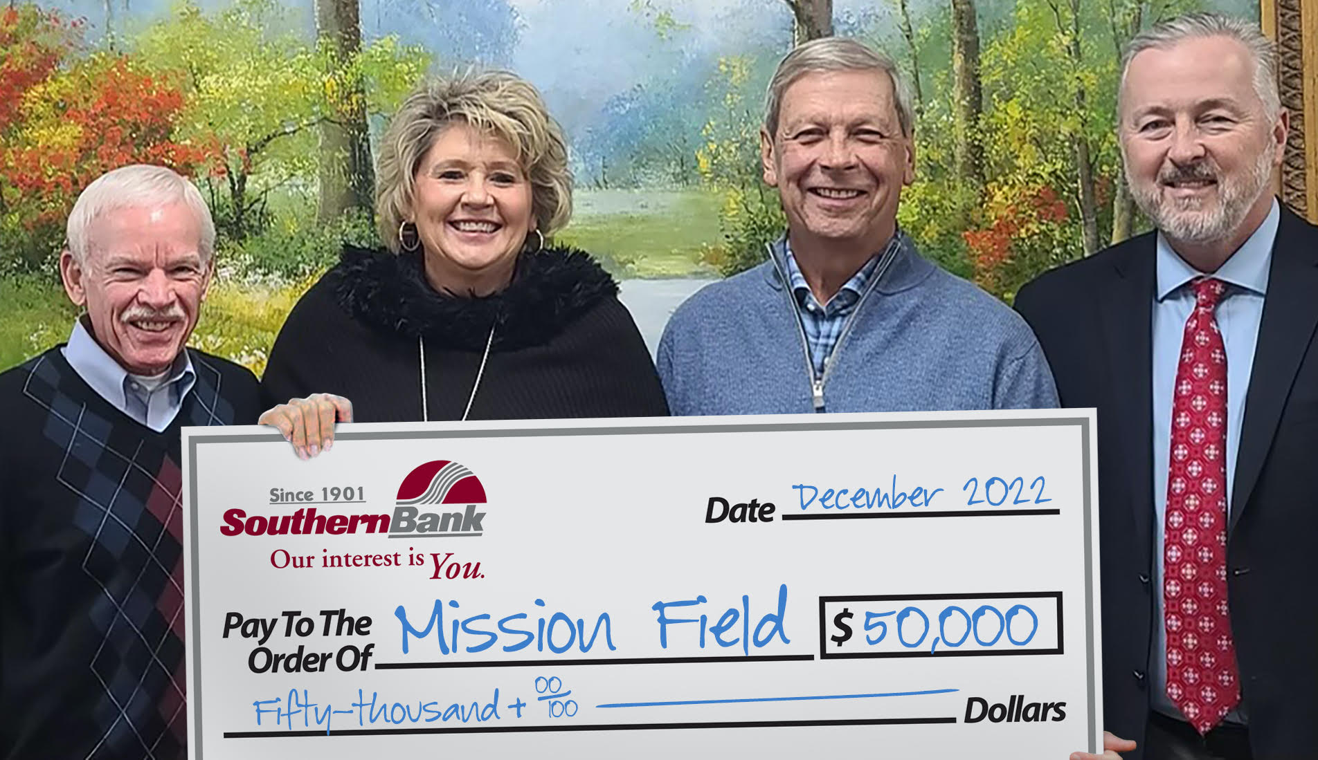Michael Bryant (far right) and Kim Sutton (second from left) of Southern Bank present a $50,000 check to Kenneth Mullen (far left) and Robert Beaman in support of Mission Field Family Park. The Southern Bank Foundation has committed a total of $100,000 to the park that will serve chil-dren and families throughout the Nash, Edgecombe, Wilson area.